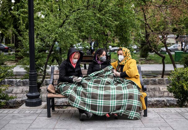 (200414) -- TEHRAN, April 14, 2020 -- Women wearing face masks sit on a bench on a street in Tehran, Iran, April 13, 2020. Iran registered 1,574 new COVID-19 cases over the past 24 hours, bringing the total number of confirmed cases to 74,877, according to Iran s health ministry on Tuesday. (Photo by Xinhua) IRAN-TEHRAN-COVID-19-CASES AhmadxHalabisaz 