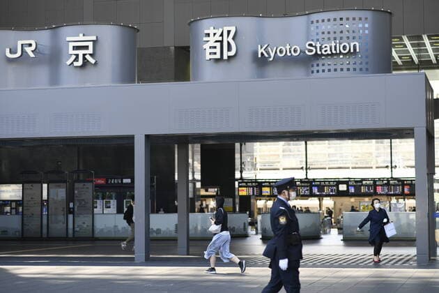 KYOTO, JAPAN - APRIL 14: Commuters wearing face mask walks in front of JR Kyoto Station on Tuesday, April 14, 2020, amid the spread of the new coronavirus. Japanese Prime Minister Shinzo Abe declared a state of emergency last week for Tokyo and six other prefectures including Kyoto to ramp up defenses against the spread of the coronavirus. (Photo: Richard Atrero de Guzman AFLO)  (125334767)