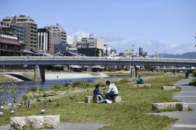 KYOTO, JAPAN - APRIL 14: People enjoys the weather near Kamogawa river in Kyoto on Tuesday, April 14, 2020, amid the spread of the new coronavirus. Japanese Prime Minister Shinzo Abe declared a state of emergency last week for Tokyo and six other prefectures including Kyoto to ramp up defenses against the spread of the coronavirus. (Photo: Richard Atrero de Guzman AFLO)  (125334776)