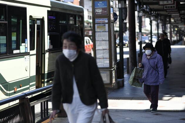 KYOTO, JAPAN - APRIL 14: Commuters wearing face mask walks in the street of Kyoto on Tuesday, April 14, 2020, amid the spread of the new coronavirus. Japanese Prime Minister Shinzo Abe declared a state of emergency last week for Tokyo and six other prefectures including Kyoto to ramp up defenses against the spread of the coronavirus. (Photo: Richard Atrero de Guzman AFLO)  (125334782)