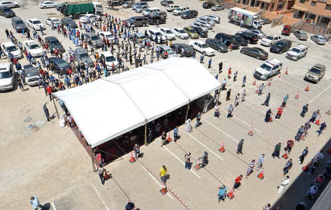 (200414) -- AHMADI GOVERNORATE, April 14, 2020 (Xinhua) -- Residents queue up to enter a new store for shopping in Mahboula area of Ahmadi Governorate, Kuwait, April 14, 2020. Kuwait opened on Tuesday a grocery store for residents of Mahboula area which is under lockdown due to the coronavirus. (Str Xinhua) KUWAIT-AHMADI GOVERNORATE-CORONAVIRUS-NEW STORE-OPENING 