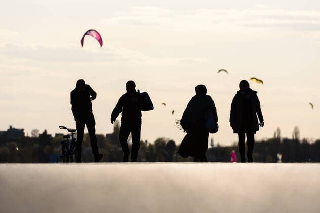 April 14, 2020: Silhouettes of people can be seen against the sky of the setting sun on the Tempelhofer Park on the site of the former Tempelhof Airport. People living in the city of Berlin have to stay in their flats or usual accommodation to contain the coronavirus, meetings of more than 2 persons are forbidden, people are asked to keep a minimum distance. - ZUMAs172 20200414_zap_s172_009 Copyright: xJanxScheunertx