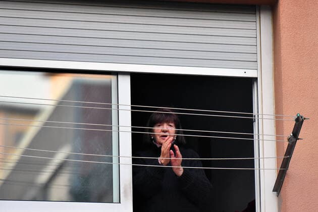 April 14, 2020, LÂ Hospitalet, Barcelona, Spain: A woman applauds Covid-19 fighters from her terrace during confinement..Citizens of LÂ Hospitalet at 8:00 pm continue to applaud showing gratitude to the people who are struggling in the fight against the Covid-19 health crisis, they give each other hope. LÂ Hospitalet Spain - ZUMAs197 20200414_zaa_s197_117 Copyright: xRamonxCostax