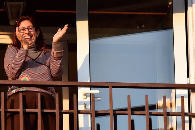 April 14, 2020, LÂ Hospitalet, Barcelona, Spain: A woman applauds Covid-19 fighters from her terrace during confinement..Citizens of LÂ Hospitalet at 8:00 pm continue to applaud showing gratitude to the people who are struggling in the fight against the Covid-19 health crisis, they give each other hope. LÂ Hospitalet Spain - ZUMAs197 20200414_zaa_s197_132 Copyright: xRamonxCostax