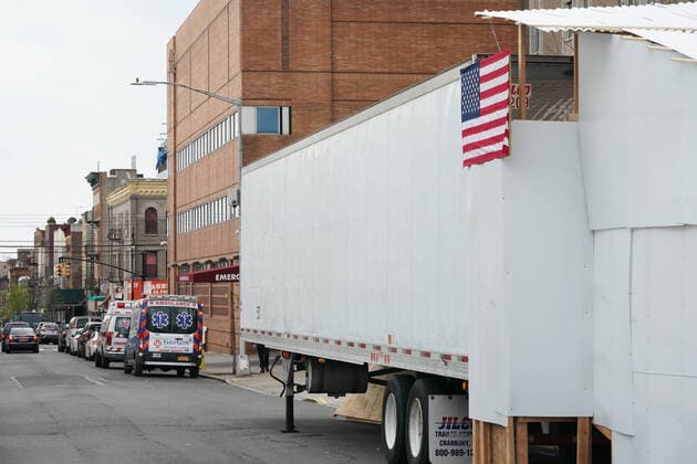 April 14, 2020, New York, NY, USA: An American flag hangs from a refrigeration truck serving as a temporary morgue outside Wyckoff Heights Medical Center in the Borough of Brooklyn on April 14, 2020 in New York. New York USA - ZUMAb148 20200414_zap_b148_009 Copyright: xBryanxSmithx