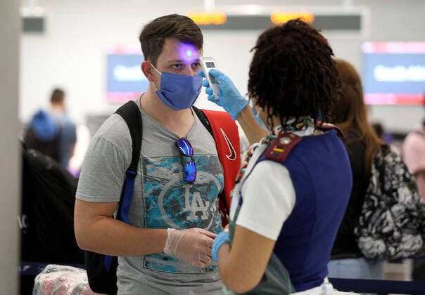 April 14, 2020, Miami, FL, USA: Rosemary Arends, an assistant nurse-flight attendant, checks the temperature of passengers and then helps a group of South African nationals at Miami International Airport boarding a special charter flight by South African Airways on Tuesday, April 14, 2020. Amid the coronavirus pandemic, the flight will repatriate more than 300 South African workers who were supposed to spend these months working at South Florida hotels and resorts. Miami USA - ZUMAm67_ 20200414_zaf_m67_031 Copyright: xPedroxPortalx
