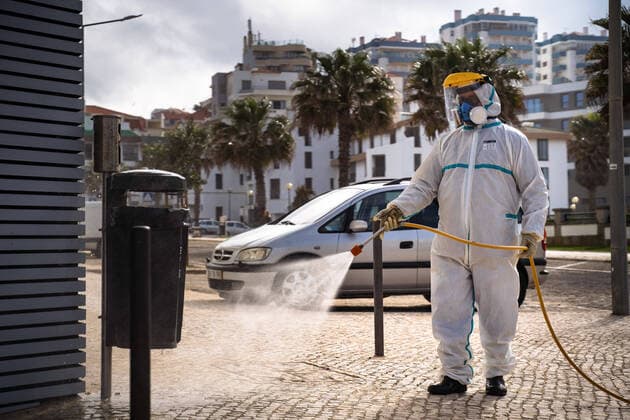 April 14, 2020, Ericeira, Portugal: An employee of the Ericeira parish council, equipped with the recommended protective materials, disinfects the street with a solution based with hypochlorite (bleach)..The municipality of Mafra had 70 cases of COVID-19 pandemic. In order to prevent the spread of the virus, the Ericeira Parish Council perform weekly street disinfection. Ericeira Portugal - ZUMAs197 20200414_zaa_s197_169 Copyright: xHenriquexCasinhasx