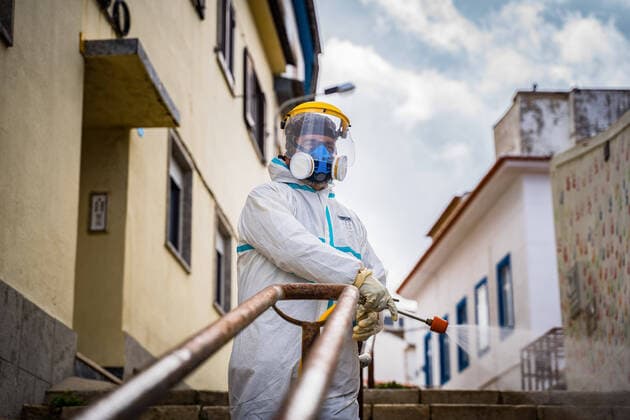 April 14, 2020, Ericeira, Portugal: An employee of the Ericeira parish council, equipped with the recommended protective materials, disinfects the street with a solution based on hypochlorite (bleach)..The municipality of Mafra had 70 cases of COVID-19 pandemic. In order to prevent the spread of the virus, the Ericeira Parish Council perform weekly street disinfection. Ericeira Portugal - ZUMAs197 20200414_zaa_s197_184 Copyright: xHenriquexCasinhasx