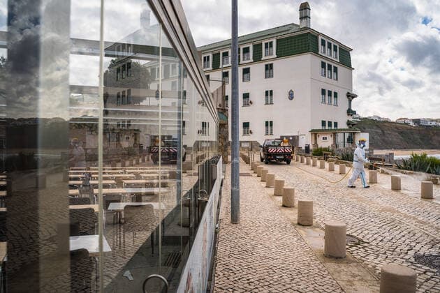 April 14, 2020, Ericeira, Portugal: An employee of the Ericeira parish council, equipped with the recommended protective materials, disinfects the street with a solution based on hypochlorite (bleach)..The municipality of Mafra had 70 cases of COVID-19 pandemic. In order to prevent the spread of the virus, the Ericeira Parish Council perform weekly street disinfection. Ericeira Portugal - ZUMAs197 20200414_zaa_s197_190 Copyright: xHenriquexCasinhasx