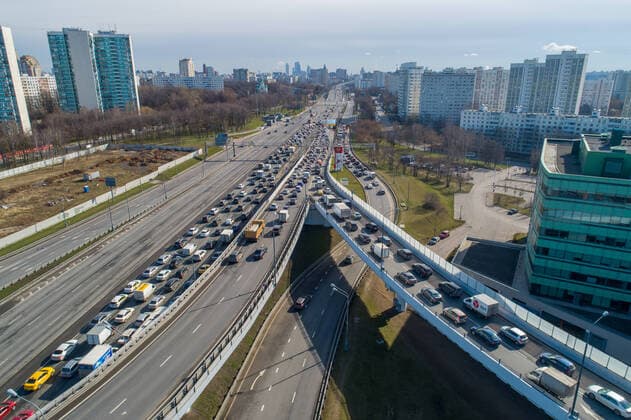 MOSCOW, RUSSIA - APRIL 15, 2020: An aerial view of a traffic congestion on an interchange of Mozhaiskoye Shosse Motorway and the MKAD Moscow Ring Road on the outskirts of Moscow during the pandemic of the novel coronavirus disease (COVID-19). Traffic police have set up checkpoints around the city to stop vehicles and see if drivers have permission to travel during the lockdown. On 13 April 2020, the Moscow government introduced a digital permit system aimed at further restricting movement. Under the new scheme, which becomes mandatory from 15 April, people need to apply for permits to travel on a vehicle or public transport around the city. Earlier, on 11 April, the Moscow government restricted vehicles registered outside Moscow Region from entering the Russian capital. Since 30 March 2020, Moscow has been on lockdown. As of 15 April 2020  TS0D5CAF