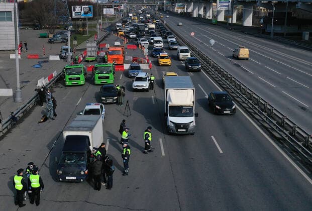 MOSCOW, RUSSIA - APRIL 15, 2020: A traffic congestion at a checkpoint on Leningradskoye Shosse Motorway at the entrance to Moscow during the pandemic of the novel coronavirus disease (COVID-19). Traffic police have set up checkpoints around the city to stop vehicles and see if drivers have permission to travel during the lockdown. On 13 April 2020, the Moscow government introduced a digital permit system aimed at further restricting movement. Under the new scheme, which becomes mandatory from 15 April, people need to apply for permits to travel on a vehicle or public transport around the city. Earlier, on 11 April, the Moscow government restricted vehicles registered outside Moscow Region from entering the Russian capital. Since 30 March 2020, Moscow has been on lockdown. As of 15 April 2020, Russia has reported more than 21,100 confirmed  TS0D5CD9