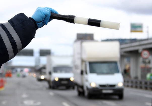 MOSCOW, RUSSIA - APRIL 15, 2020: A traffic police officer carries out ID checks on Leningradskoye Shosse Motorway at the entrance to Moscow during the pandemic of the novel coronavirus disease (COVID-19). Traffic police have set up checkpoints around the city to stop vehicles and see if drivers have permission to travel during the lockdown. On 13 April 2020, the Moscow government introduced a digital permit system aimed at further restricting movement. Under the new scheme, which becomes mandatory from 15 April, people need to apply for permits to travel on a vehicle or public transport around the city. Earlier, on 11 April, the Moscow government restricted vehicles registered outside Moscow Region from entering the Russian capital. Since 30 March 2020, Moscow has been on lockdown. As of 15 April 2020, Russia has reported more than 21,100  TS0D5CE2