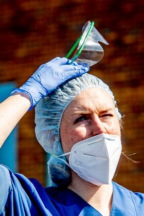 April 15, 2020, Uden, Netherlands: A health personnel wearing protective gear as a preventive measure, looks on as they transport a patient to the helicopter..The trauma helicopter, the lifeliner 5, transports an IC covid-19 patient from the Bernhoven hospital to the umc Groningen. Corona virus patients are spread across the Netherlands and the trauma helicopter serves specifically corona virus victims. Uden Netherlands - ZUMAs197 20200415_zaa_s197_084 Copyright: xRobinxUtretchtx
