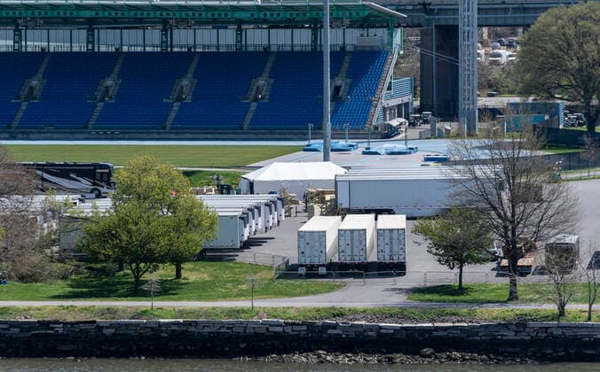 Live in New York amid COVID-19 epidemic Dozens of refrigerated trucks and containers seen on Randall s Island prepared for influx of dead bodies as makeshift morgues amid COVID-19 pandemic New York New York United States Copyright: LevxRadin