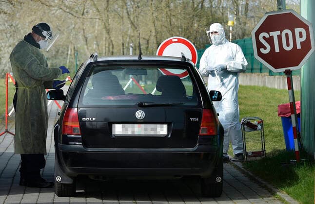 Paramedics take samples for covid-19 tests in drive-through testing station near the Domazlice Hospital, Czech Republic, on Wednesday, April 15, 2020. (CTKxPhoto MiroslavxChaloupka) CTKPhotoP202004150450701 cha001