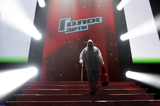 MOSCOW, RUSSIA - APRIL 16, 2020: A worker in a protective suit disinfecting the studio of The Voice Kids Russia reality TV singing competition ahead of a live broadcast scheduled for April 17; the shooting will be held without spectators and with the fewest possible members of the crew. Artyom Geodakyan TASS  TS0D60E1