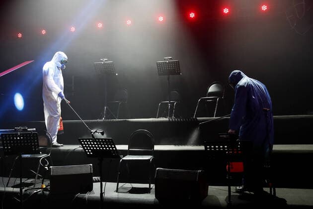 MOSCOW, RUSSIA - APRIL 16, 2020: Workers in protective suits disinfecting the studio of The Voice Kids Russia reality TV singing competition ahead of a live broadcast scheduled for April 17; the shooting will be held without spectators and with the fewest possible members of the crew. Artyom Geodakyan TASS  TS0D60E2