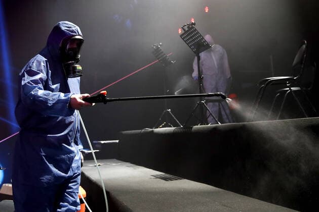 MOSCOW, RUSSIA - APRIL 16, 2020: Workers in protective suits disinfecting the studio of The Voice Kids Russia reality TV singing competition ahead of a live broadcast scheduled for April 17; the shooting will be held without spectators and with the fewest possible members of the crew. Artyom Geodakyan TASS  TS0D60E3