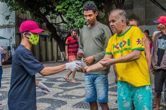 April 19, 2020, Rio de Janeiro, Brazil: A group of favela residents in Rio, joining a collective called Marcha das Favelas , and are trying to help reduce the needs of homeless people by distributing food and water through the city ‹‹center. The current political situation in which the state leaves the lower classes. With unemployment and poverty, the number of homeless people is increasing every day. Now with the coronavirus that is isolating the population from the streets, the difficulty of homeless people to get a plate of food is growing in the big cities of Brazil. Rio de Janeiro Brazil  - ZUMAent 20200419_mda_l255_034 Copyright: xEllanxLustosax