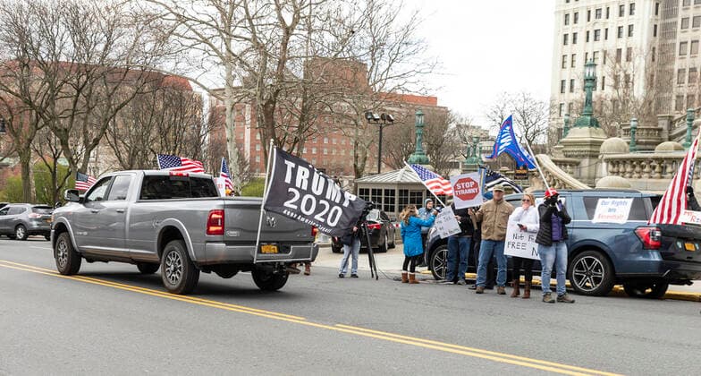 NY: Operation Gridlock in Albany People in cars and on streets with American flags and Trump flags participate in Operation Gridlock protest outside of New York State Capitol Building. Participants demanded reopening of New York State. Many people on the street disregarded wearing facial masks and keep social distances. Albany New York United States Copyright: LevxRadin