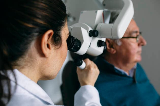 ENT physician examining ear of a senior man model released Symbolfoto property released ABZF03027