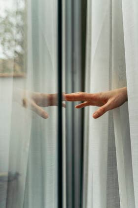 Hand of a woman touching windowpane model released Symbolfoto property released AFVF05958