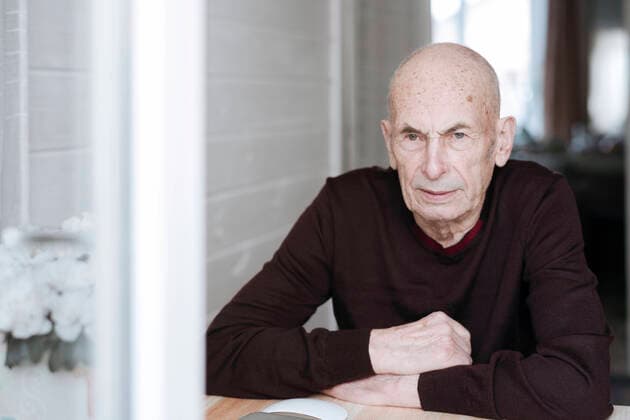 Portrait of pensive old man sitting at table looking out of window model released Symbolfoto property released EYAF01000