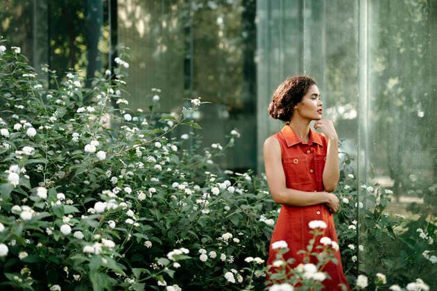 Pensive young woman standing in urban garden model released Symbolfoto TCEF00379