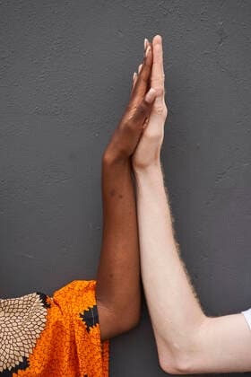 Couple joining hands in front of grey background model released Symbolfoto VEGF01741