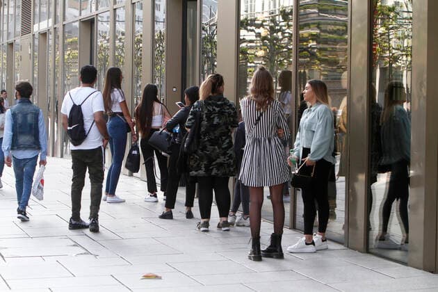 Warteschlange von Kunden, die ein Geschäft in der Einkaufsstraße und Fußgängerzone Zeil der Innenstadt von Frankfurt betreten wollen, Hessen, Deutschland. Das Geschäft lässt aus Gründen der Abstandswahrung nur eine bestimmte Anzahl von Kunden den Laden betreten.