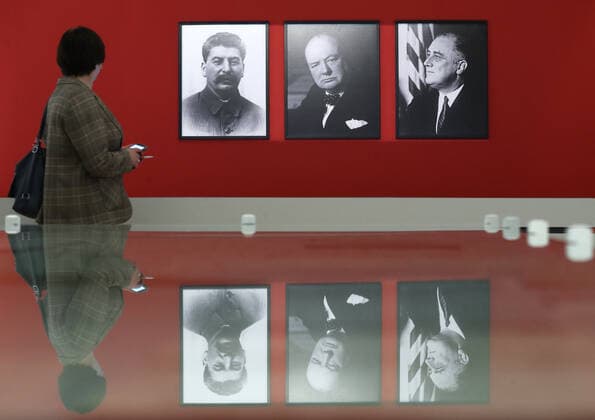 MOSCOW, RUSSIA - APRIL 24, 2020: A visitors views photographs of the UK Prime Minister Winston Churchill, the US President Franklin Roosevelt, and Soviet leader Joseph Stalin at the exhibition titled Stalin, Churchill, Roosevelt: the Common Struggle against Fascism , which is held at Russiaâ€™s Federal Archival Agency. Supported by the Russian Presidential Grants Foundation, the exhibition shows the key documents and items in the formation of the Allies of World War II during the Great Patriotic War 1941â€“1945 (the Eastern Front of World War II). Mikhail Tereshchenko TASS  TS0D7246