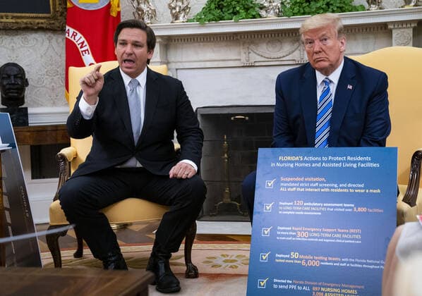President Donald Trump looks on as Florida Governor Ron DeSantis makes remarks during a meeting in the Oval Office, Tuesday, April 28, 2020.  WAX20200428419 DougxMills