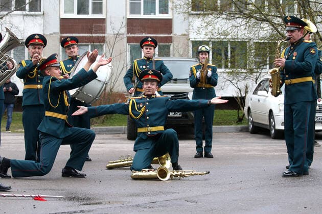 ST PETERSBURG, RUSSIA â€“ APRIL 30, 2020: A military orchestra of the Special Purpose Motor Rifle Brigade of the Combined Arms Army of the Russian Western Military District perform during a private parade for WWII veteran Mikhail Polyachkov as part of the Supporting Veterans initiative organised to mark the forthcoming Victory Day. Mikhail Polyachkov watched the parade from his balcony. This year, Russia is celebrating the 75th anniversary of the victory over Nazi Germany in the Great Patriotic War of 1941â€“1945 (the Eastern Front of World War II). Peter Kovalev Private parade for WWII veteran in St Petersburg