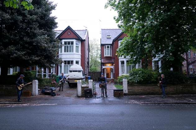 (200501) -- MANCHESTER, May 1, 2020 (Xinhua) -- Residents of the Wood Road in Chorlton play instruments in a street concert as part of the weekly Clap for Our Carers in Manchester, Britain, on April 30, 2020. (Photo by Jon Super Xinhua) BRITAIN-MANCHESTER-COVID-19-STREET CONCERT 