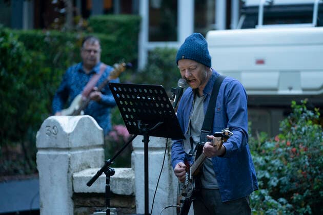(200501) -- MANCHESTER, May 1, 2020 (Xinhua) -- Residents of the Wood Road in Chorlton play instruments in a street concert as part of the weekly Clap for Our Carers in Manchester, Britain, on April 30, 2020. (Photo by Jon Super Xinhua) BRITAIN-MANCHESTER-COVID-19-STREET CONCERT 