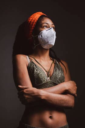 Portrait of young woman wearing face mask and looking outside during Coronavirus lockdown in Colombia Colombia Copyright: xNanoxCalvox NN-CORONA-91