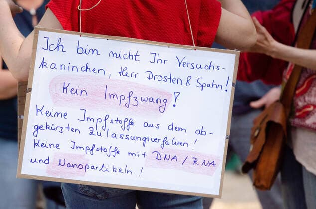 Coronavirus, Demonstration gegen Corona-Maßnahmen Demonstrant hält Tranparent mit der Aufschrift Ich bin nicht ihr Versuchskaninchen, Herr Dronsten & Spahn! Kein Impfzwang! Keine Impfstoffe aus den abgekürztem Zulassungsverfahren! Kein Impfstoff mit DNA RNA und Nanopartikeln!, am 09.05.2020 in Flensburg, Hafen, Hafenspitze