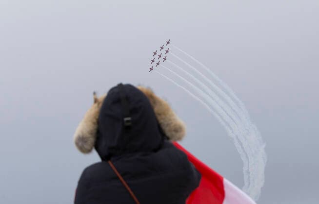 (200510) -- TORONTO, May 10, 2020 -- A woman watches a formation of the Canadian Forces Snowbirds as part of their Operation Inspiration Tour during the COVID-19 outbreak over Toronto, Canada, on May 10, 2020. From the first weekend of May, the cross-country tour is expected to salute Canadians doing their part to fight the spread of COVID-19. (Photo by Xinhua) CANADA-TORONTO-COVID-19-SNOWBIRDS-FLYOVER ZouxZheng 