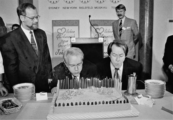 Ministerpraesident Johannes Rau pustet Kerzen aus Auf dem SPD Landesparteitag in Bielefeld wird Johannes Raus 63. Geburtstag gefeiert. Rudolf Scharping,links, schaut zu, wie Rau mit Hilfe von Franz Muentefering,rechts,seine Geburtstagskerzen auspustet. Bielefeld Germany *** State Premier Johannes Rau blows out candles At the SPD state party conference in Bielefeld, Johannes Raus 63rd birthday is celebrated Rudolf Scharping,left, watches Rau blow out his birthday candles with the help of Franz Muentefering,right Bielefeld Germany