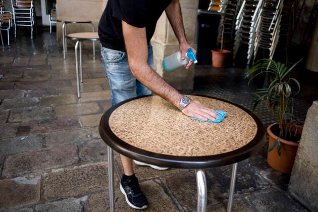 May 25, 2020, Barcelona, Catalonia, Spain: Alex disinfects a table just before opening the terrace of the bar where he works in Barcelona. Barcelona and its metropolitan area enter Phase 1 of the coronavirus lockdown de-escalation process from this Monday, the terraces of bars and restaurants can open to half their capacity after 2 months of being closed. Barcelona Spain - ZUMAb137 20200525_zap_b137_014 Copyright: xJordixBoixareux