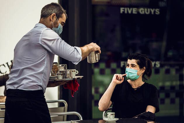 May 25, 2020: Barcelona, Spain: A customer talks to her waiter at a terrace bar at Barcelona s Plaza Catalunya as Barcelona enters the second phase of a gradual way to the new normal rolling back a nearly seven weeks long nationwide strict lockdown due to the spread of the corona virus. Today Barcelona enters the second of four phases as one of the last territories permitting the restricted reopening of hotels, museums, libraries, shops and bar terraces among other measures of ease. - ZUMAo105 20200525_zap_o105_007 Copyright: xMatthiasxOesterlex