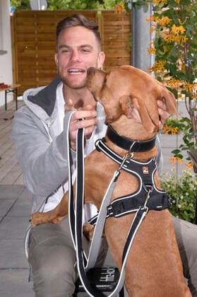 Sebastian Preuss (mit Hund Chopper) übergibt den Tierpflegern des Tierheims München zum Dank für ihren Einsatz während der Corona-Pandemie Rote Rosen. München, 25.05.2020