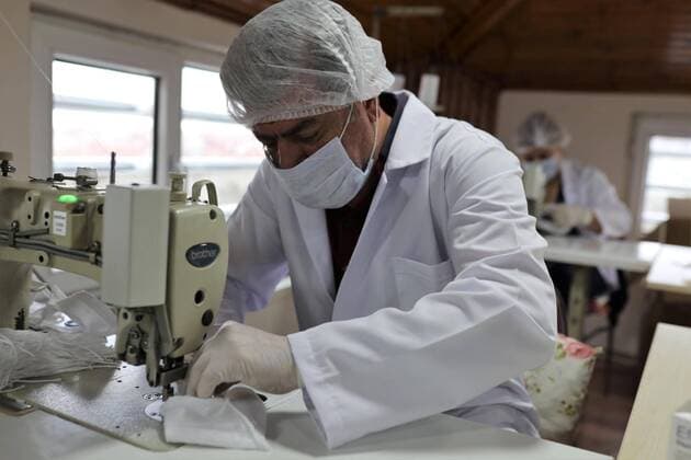 (200527) -- ISTANBUL, May 27, 2020 (Xinhua) -- Workers make transparent face masks in Istanbul, Turkey, May 27, 2020. The Avcilar Municipality has recently decided to produce specially designed tailor-made facial masks for people with hearing disabilities amidst the COVID-19 pandemic after observing that regular masks seriously limit their communication, making the lip-reading impossible. TO GO WITH Feature: Transparent masks produced in Istanbul for hearing impaired amid COVID-19 (Photo by Osman Orsal Xinhua) TURKEY-ISTANBUL-COVID-19-TRANSPARENT MASK 