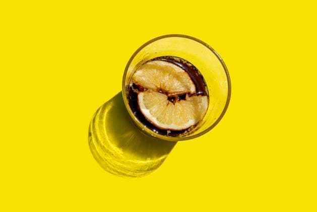 Studio shot of glass of cola with lemon slices GEMF03609