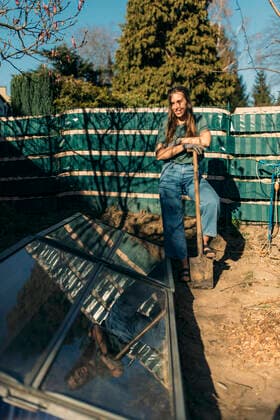 Young woman with in garden standing at self-made greenhouse model released Symbolfoto property released GUSF03626