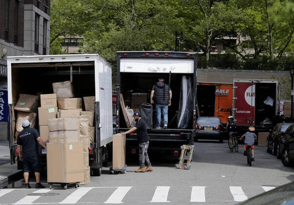 Moving trucks, workers and boxes dominate a street on the Upper West Side of Manhattan in the days of the Coronavirus Pandemic in New York City on Wednesday, May 27, 2020. New Yorkers cannot be evicted for failing to pay their rent amid the coronavirus crisis. Gov. Andrew M. Cuomo recently announced a 60-day extension through August 20 of a moratorium that was scheduled to end in June. More than 5.5 million cases of COVID-19 have been reported worldwide resulting in over 345,000 deaths.  NYP20200527104 JOHNxANGELILLO