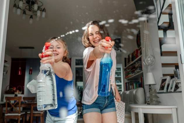 Two sisters splashing with window cleaner model released Symbolfoto property released OGF00300