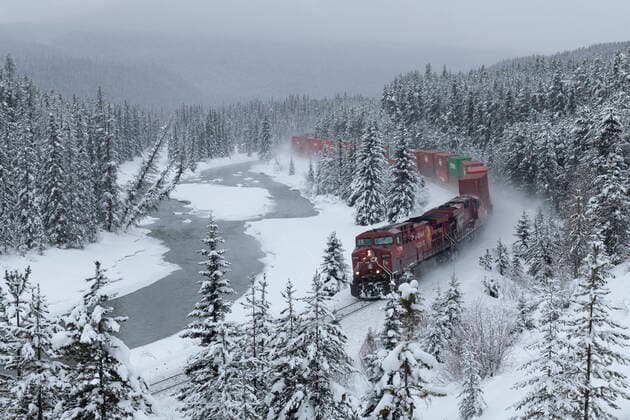 Canadian Pacific train at Morant s Curve in winter along the Bow River, Banff National Park, UNESCO World Heritage Site, Alberta, Canada, North America Copyright: EdxRhodes 1306-726 Editorial Use Only