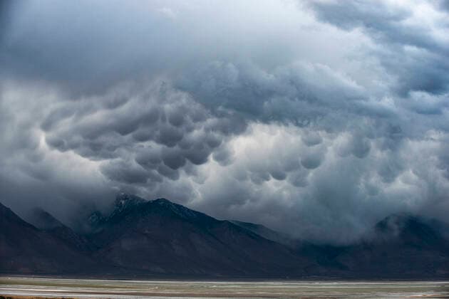 A Storm Passes Through the Badwater Basin Salt Flats Desert In D Death Valley Junction, CA, United States CR_GASU200409D-337674-01