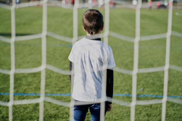 Rear view behind the net of a child football goalkeeper in the goal Pamplona, Navarre, Spain CR_SEBO200420B-342921-01,model released, Symbolfoto